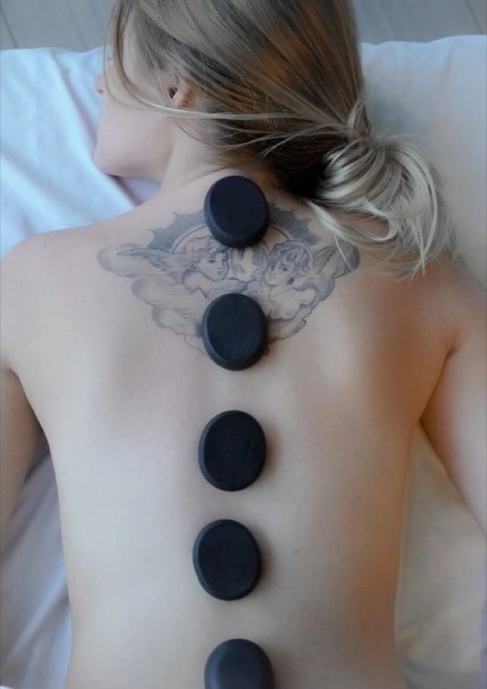 Hot stone therapy during a holistic massage session
